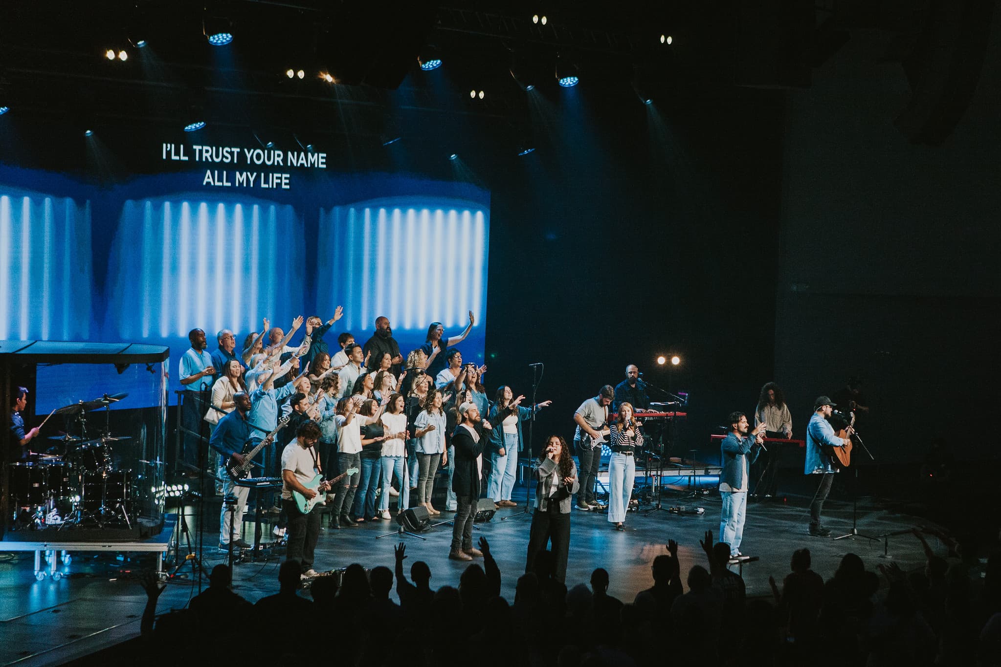 Joe Richardson leading worship with the Mercy Hill Church band and choir